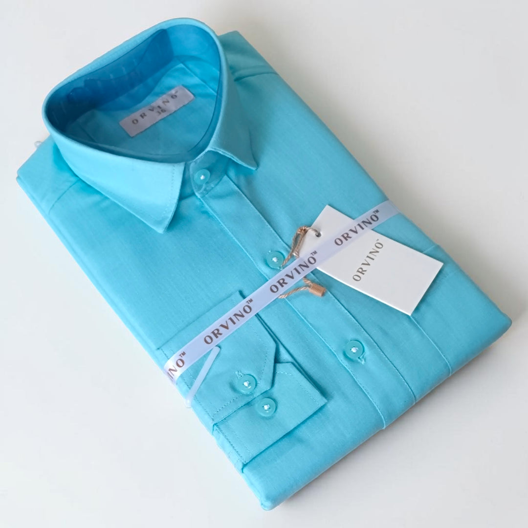 Folded turquoise shirt with a tag on a white background